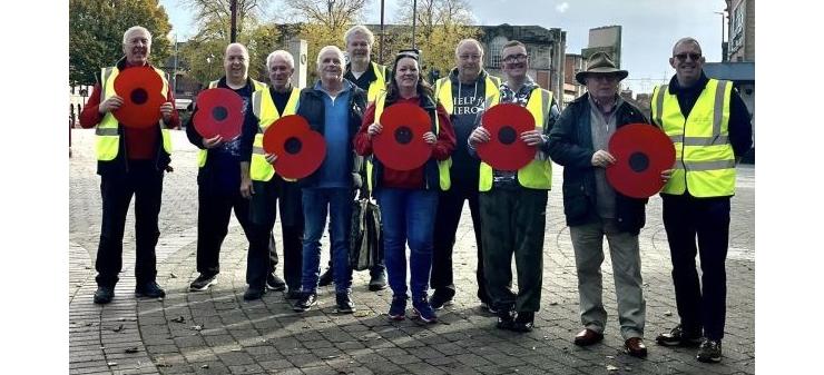 Volunteers with the lamppost poppies for 2023