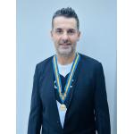 Darren Messias wearing his Fellow with Distinction medal - credit - Toast PR