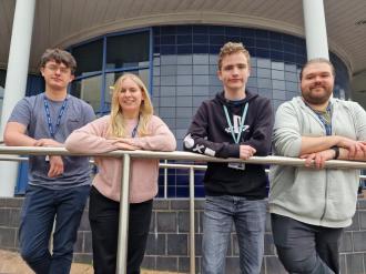 from left: Daniel Ash is pictured (second right) with, from left: support worker Ben Kendall and Games Development teachers Leigh Champion and Nathan Rogers.
