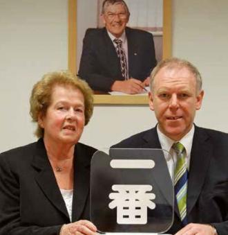 Elsie Brooks and Kevin Slack with the firm's recent Toyota Ichiban Award - with the late Ron Brooks pictured behind