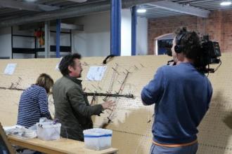 Filming of Richard looking at a laid out harness, in the laying department