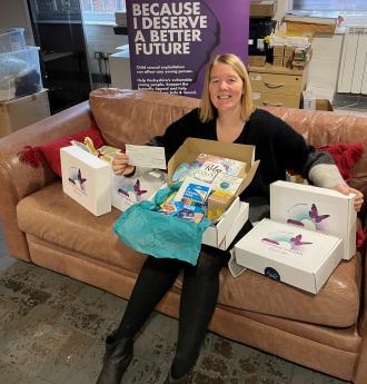 Picture shows, Safe and Sound CEO Tracy Harrison with the cheque and some Hope boxes.
