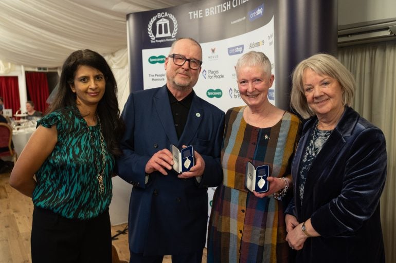 Chris and Denise Mitchell are pictured receiving their British Citizen Award from Dame Mary Perkins, founder of Specsavers and BCA Patron, together with TV and radio presenter Konnie Huq who hosted the awards